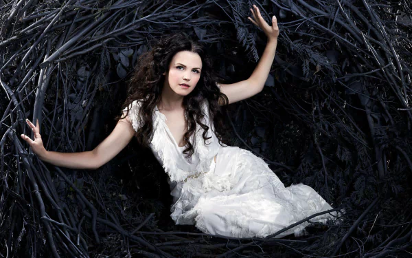 Snow White, portrayed by Ginnifer Goodwin in Once Upon A Time, emerges from a dark, twisted nest, showcasing a captivating blend of fairy tale and drama.
