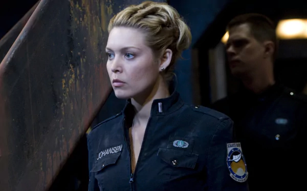 HD desktop wallpaper featuring Tamara Johansen (Alaina Huffman) from the TV show Stargate Universe, dressed in a dark uniform with a serious expression.