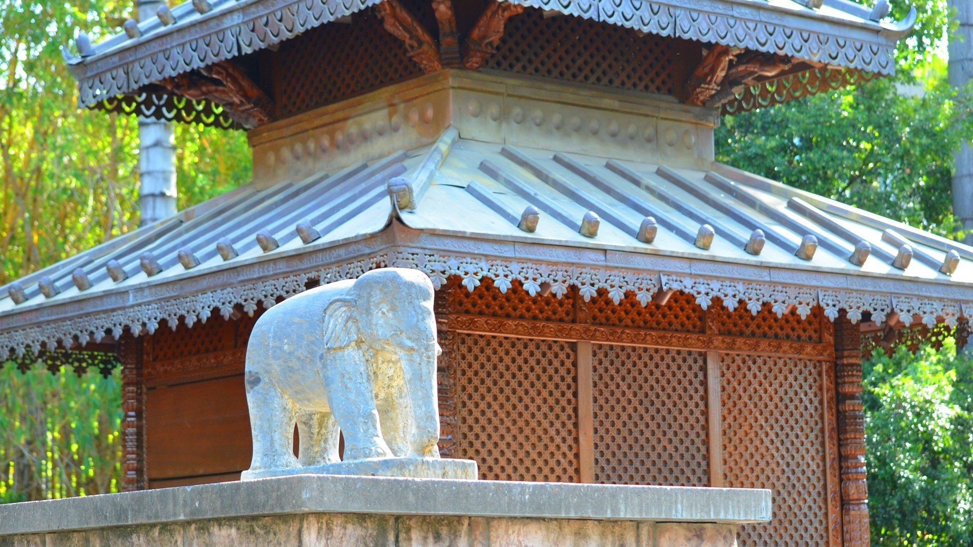 Nepalese pagoda architecture in Brisbane, Australia with a carved elephant statue on a man-made plinth — HD PC desktop wallpaper