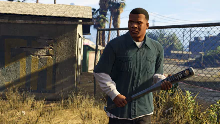 HD desktop wallpaper featuring Franklin Clinton from Grand Theft Auto V, holding a baseball bat in a rundown urban setting.