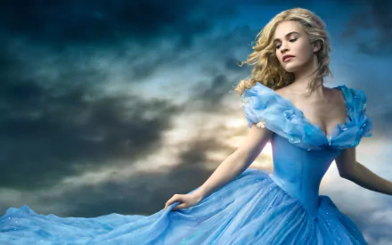 Lily James as Cinderella in a stunning blue gown, set against a dramatic sky. A captivating HD wallpaper from the 2015 film, showcasing her enchanting presence.