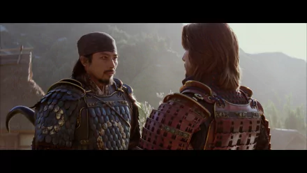 Two samurai in traditional armor converse in a serene setting, captured in an HD wallpaper from the movie The Last Samurai. The image reflects themes of honor and conflict.