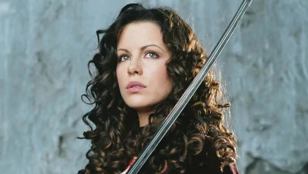 A striking HD wallpaper featuring Kate Beckinsale as she appears in the movie Van Helsing, showcasing her with a sword against a dramatic backdrop.
