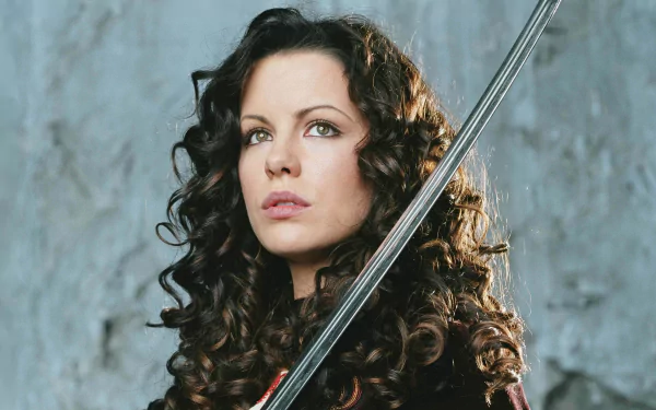 A striking HD wallpaper featuring Kate Beckinsale as she appears in the movie Van Helsing, showcasing her with a sword against a dramatic backdrop.