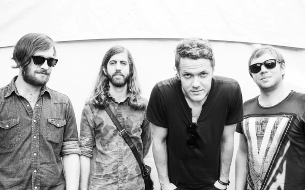 Black and white HD wallpaper featuring the American alternative band Imagine Dragons, showcasing the four band members in a striking pose. Perfect for music lovers.