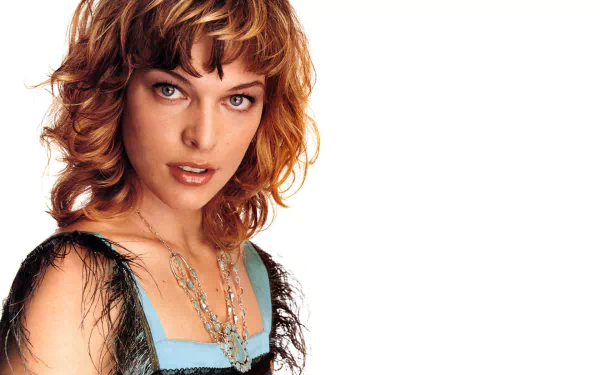 HD desktop wallpaper featuring a close-up portrait of celebrity Milla Jovovich with curly hair and layered necklaces against a white background.