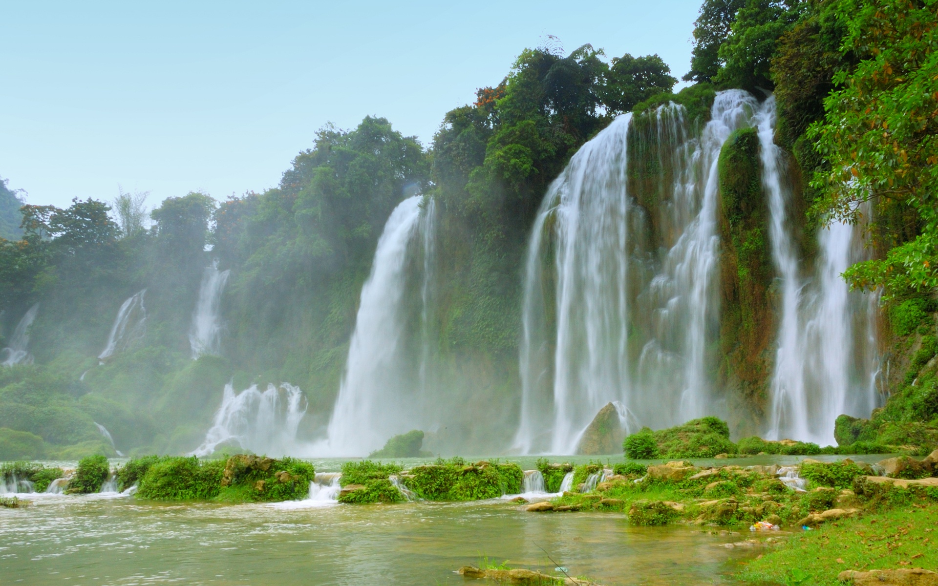 Ban Gioc-Detian Falls in Vietnam, showcasing stunning nature with lush vegetation and flowing water.