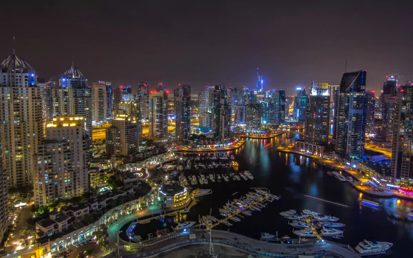 A stunning 4K Ultra HD night view of Dubai’s man-made marina, illuminated skyscrapers, and waterfront, showcasing the vibrant cityscape and luxury yachts.