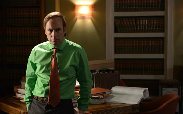 HD desktop wallpaper featuring Saul Goodman from Breaking Bad, portrayed by Bob Odenkirk, in a professional setting with a bookshelf background.