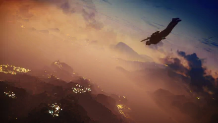 Rico Rodriguez from Just Cause 3 glides through the sky at sunset in a dynamic HD PC desktop wallpaper from the video game Just Cause.