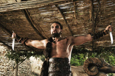 A dynamic scene featuring Drogo from Game of Thrones, portrayed by Jason Momoa, confidently wielding knives in a striking HD wallpaper background.