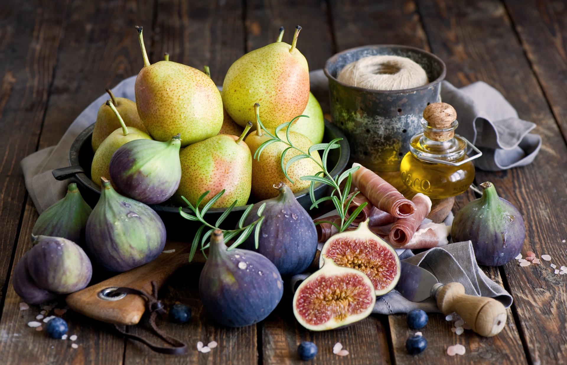 HD PC desktop wallpaper and background: pears and figs arranged with olive oil, prosciutto, salt and herbs on a rustic wooden table — fresh pear and fig food fruit still life.
