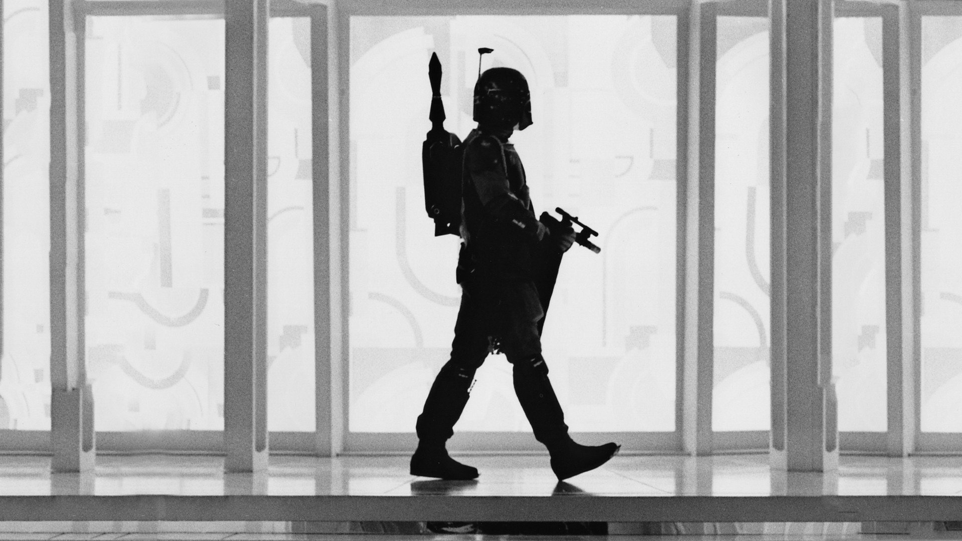 Silhouette of Boba Fett walking in a bright hallway, featured as an HD PC desktop wallpaper from the Star Wars movie series.