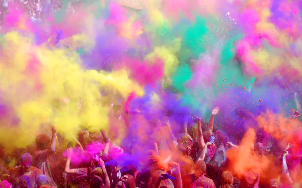 Vibrant Holi festival scene with people celebrating, surrounded by clouds of colorful powder in bright hues, captured as an HD PC desktop wallpaper background.