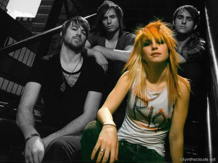 HD PC desktop wallpaper featuring the rock band Paramore, with lead singer Hayley Williams in colorful contrast against a black-and-white background of band members.