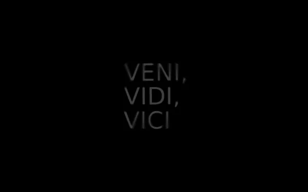 Minimalist HD PC wallpaper featuring Julius Caesar’s quote Veni, Vidi, Vici in artistic black typography on a dark background.