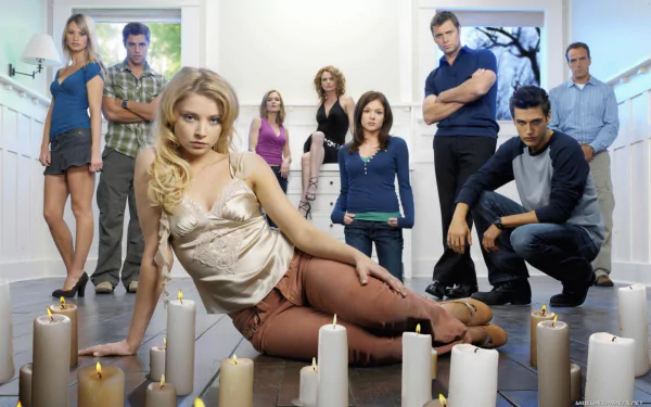 HD desktop wallpaper featuring Elisabeth Harnois and cast from the TV show Point Pleasant, surrounded by lit candles in a dramatic group pose.