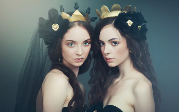 Portrait of two artistic models with crowns and black floral headpieces, captured in 4K Ultra HD, featuring Klara Koy with expressive faces and flowing hair in a Paris-inspired setting.