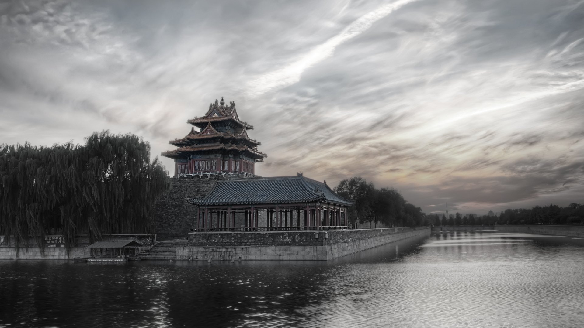 HD desktop wallpaper showcasing the Forbidden City under a dramatic sky, highlighting its historic architecture by the calm waters.