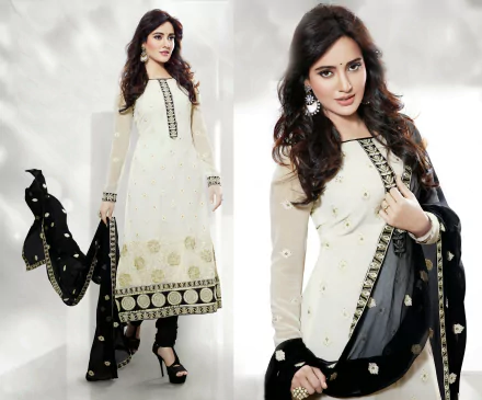 A model in traditional Indian national dress, featuring a white and black ensemble with intricate designs. Neha Sharma showcases elegance in this stunning 4K Ultra HD background.