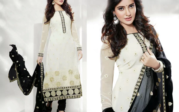 A model in traditional Indian national dress, featuring a white and black ensemble with intricate designs. Neha Sharma showcases elegance in this stunning 4K Ultra HD background.
