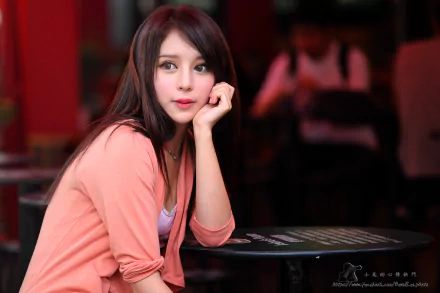 Taiwanese Asian female model in a pink cardigan, seated at a café table with soft bokeh background — 5K Ultra HD desktop wallpaper.