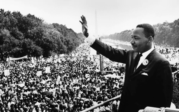 Black and white HD desktop wallpaper of Martin Luther King Jr. waving to a large crowd during a historic civil rights event.
