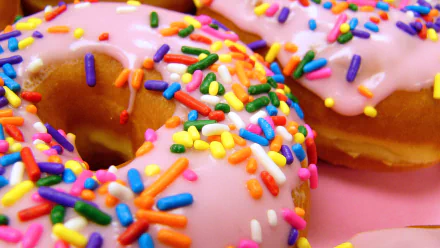 HD PC desktop wallpaper: close-up of pink-glazed doughnuts (dougnut) with rainbow sprinkles on a pink background — colorful food image.