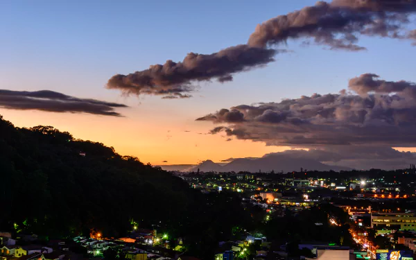 Evening sky over San Salvador, El Salvador, with vibrant clouds and city lights, captured in stunning 4K Ultra HD detail.