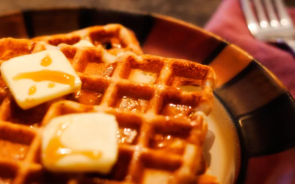 HD PC desktop wallpaper/background: close-up of golden waffles on a plate topped with melting pats of butter and drizzled syrup, food/waffle image.