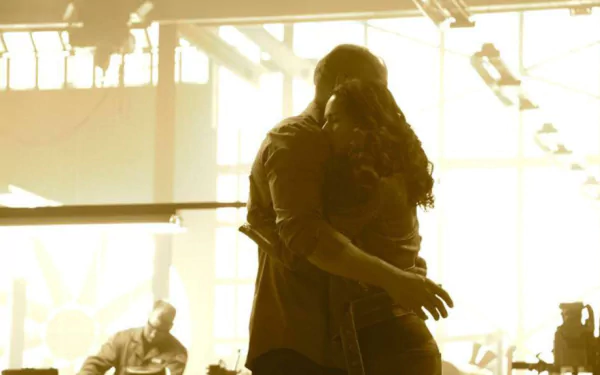 A warm and emotional scene from Furious 7, featuring two characters embracing, set against a backdrop of dramatic lighting. This HD wallpaper captures a poignant moment from the film.