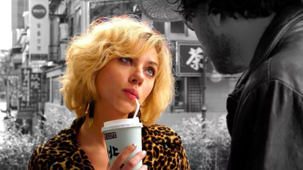 HD PC desktop wallpaper featuring Scarlett Johansson as Lucy from the movie Lucy, set against a black and white urban background, highlighting vivid color accents.