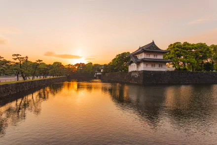 Sunset over the Tokyo Imperial Palace in Japan, reflecting on the calm waters surrounding the historic man-made residence, captured in 4K Ultra HD.
