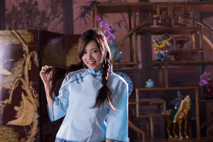 Portrait of Taiwanese model Chén Sīyǐng smiling with braided hair, wearing a light blue traditional outfit, captured in 4K Ultra HD for a PC desktop wallpaper.