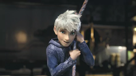 Jack Frost from the movie Rise of the Guardians smiles while holding onto a rope, set against a mystical backdrop. This HD wallpaper captures his playful spirit perfectly.