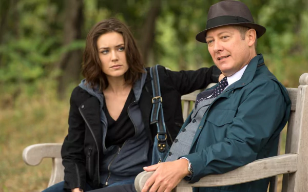HD wallpaper featuring two characters from The Blacklist, including James Spader, sitting on a park bench.