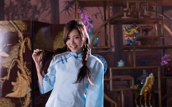 Portrait of Taiwanese model Chén Sīyǐng smiling with braided hair, wearing a light blue traditional outfit, captured in 4K Ultra HD for a PC desktop wallpaper.
