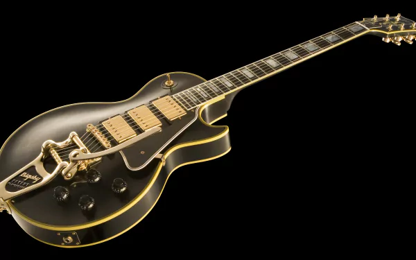 4K Ultra HD PC desktop wallpaper featuring a sleek black electric guitar with gold accents on a black background, highlighting musical craftsmanship.