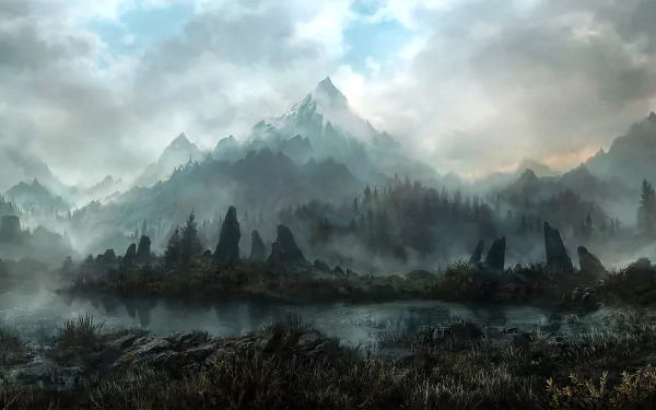 HD desktop wallpaper and background depicting a tranquil nature scene with a misty mountain range towering over a serene, grassy landscape, covered in dense fog under a cloudy sky.