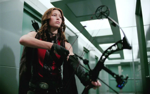 HD PC desktop wallpaper from the movie Blade: Trinity featuring a focused female archer aiming her bow in a modern, sleek hallway setting.