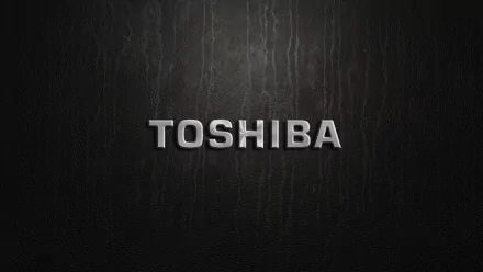 HD PC desktop wallpaper featuring a sleek, metallic Toshiba logo on a textured dark background, showcasing a modern man-made design.
