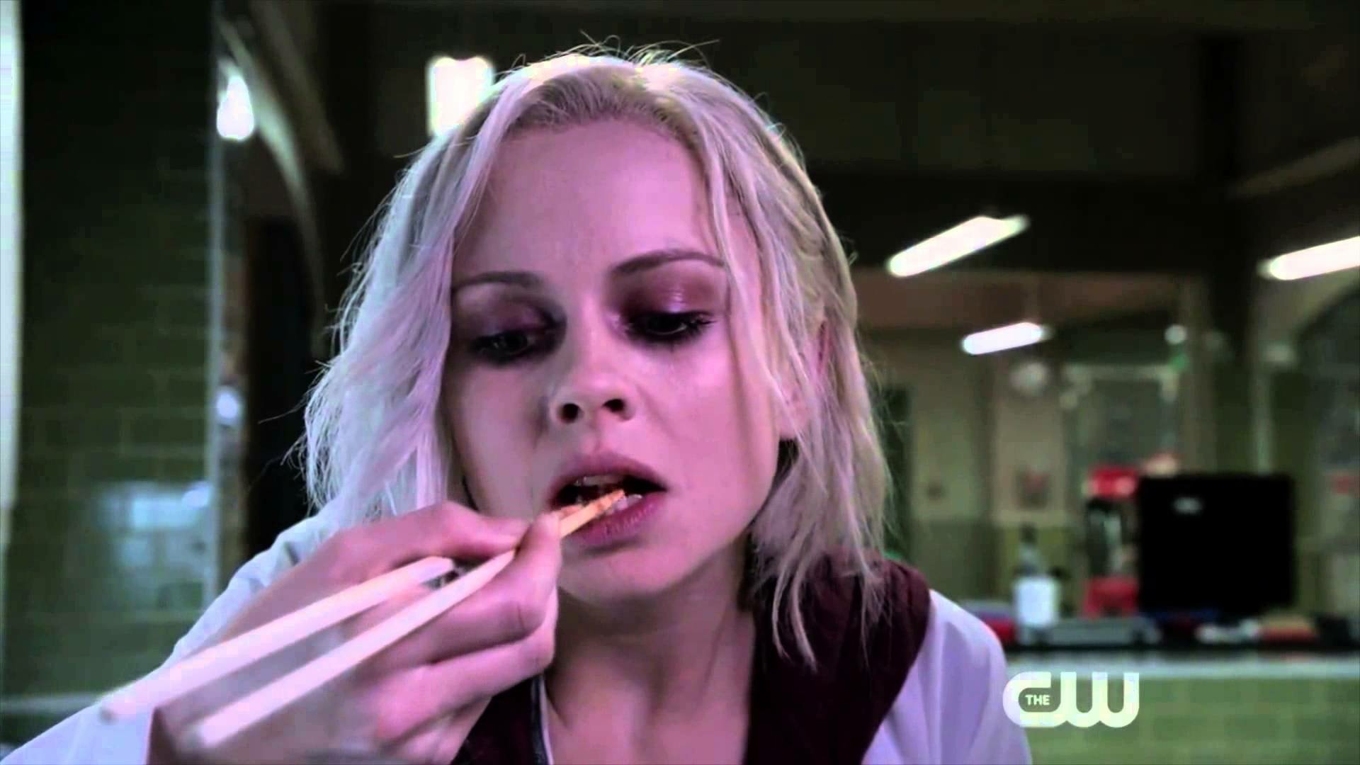 HD PC desktop wallpaper from the TV show iZombie featuring a close-up of a woman with pale skin and blonde hair eating with chopsticks in a dimly lit setting.