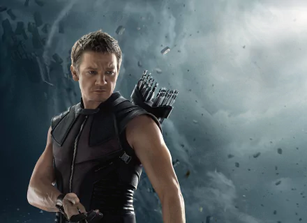 HD desktop wallpaper featuring Jeremy Renner as Hawkeye from the movie Avengers: Age of Ultron, set against a dramatic, cloudy background.