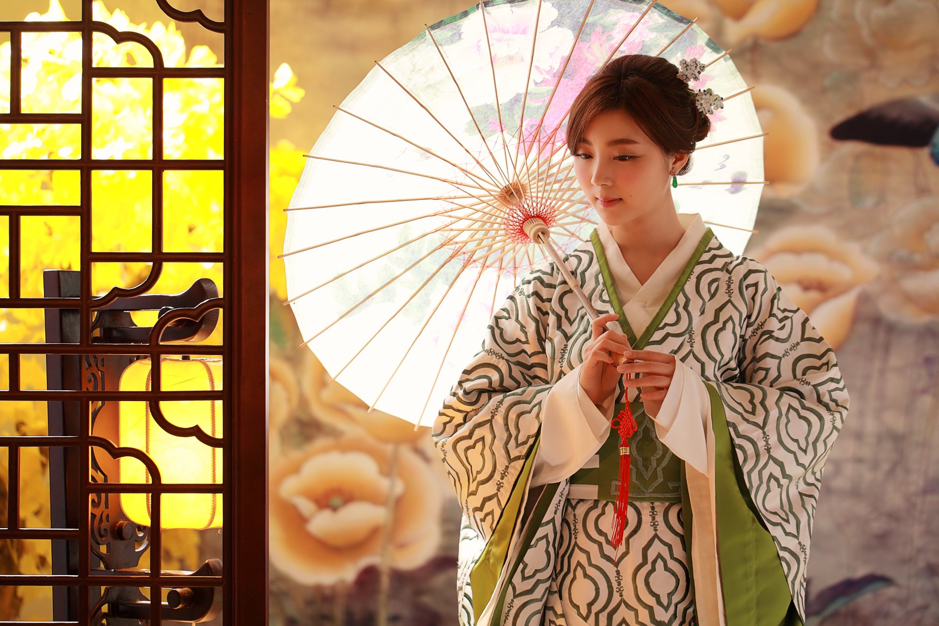 A Taiwanese woman in traditional costume holds a decorative umbrella indoors, styled with an elegant hairdo, featured in a 4K Ultra HD wallpaper by Patty Yong.
