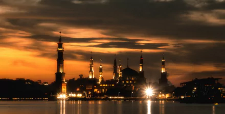 Samarinda Islamic Center in East Kalimantan, Borneo, is beautifully illuminated under a night sky, reflecting the peaceful ambiance of Islam in Indonesia.