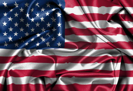 A high-definition desktop wallpaper featuring the American flag, beautifully displayed with flowing fabric textures that emphasize its vibrant colors and iconic design.