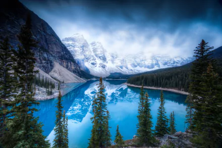 A stunning view of Moraine Lake in Banff National Park, showcasing the reflection of the Valley of Ten Peaks in the vibrant blue water, surrounded by lush evergreens and majestic mountains.