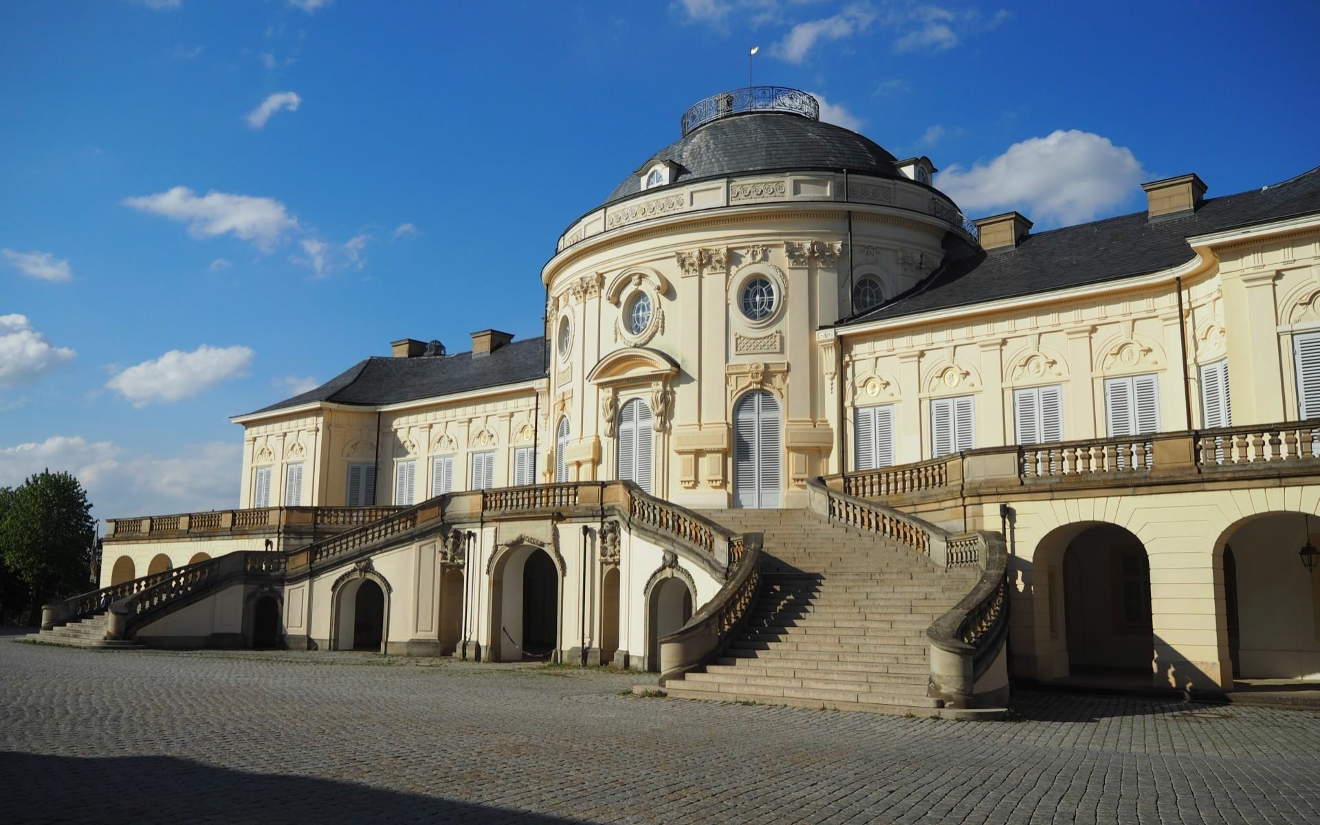 HD PC desktop wallpaper and background: Castle Solitude, a man-made Baroque palace with a domed central pavilion, sweeping twin staircases and pale façades under a bright blue sky.