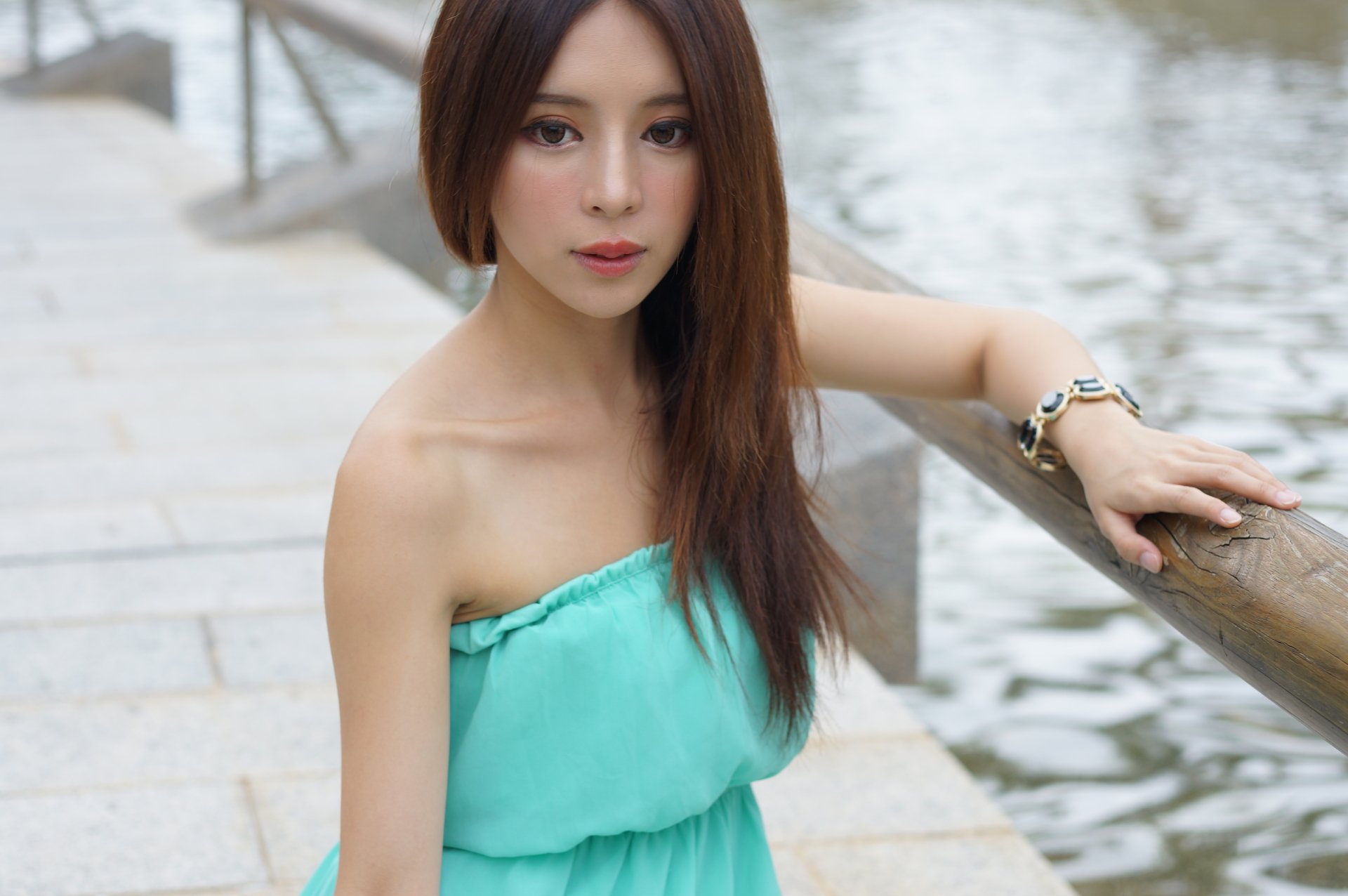 Portrait of Taiwanese model Julie Chang wearing a green dress and bracelet, posing by water, captured in 4K Ultra HD for a PC desktop wallpaper.