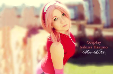 HD desktop wallpaper featuring a woman cosplaying as Sakura Haruno, tagged Mia Haks. She is dressed in a vibrant costume, set against a soft-focus cityscape background.